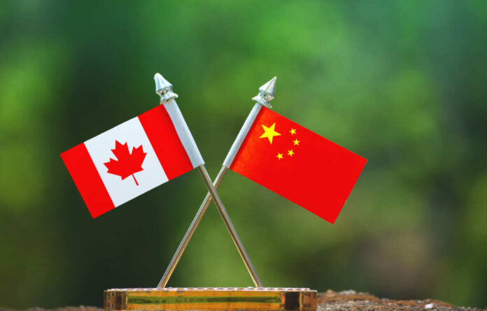 China,And,Canada,Small,Flag,With,Blur,Green,Background