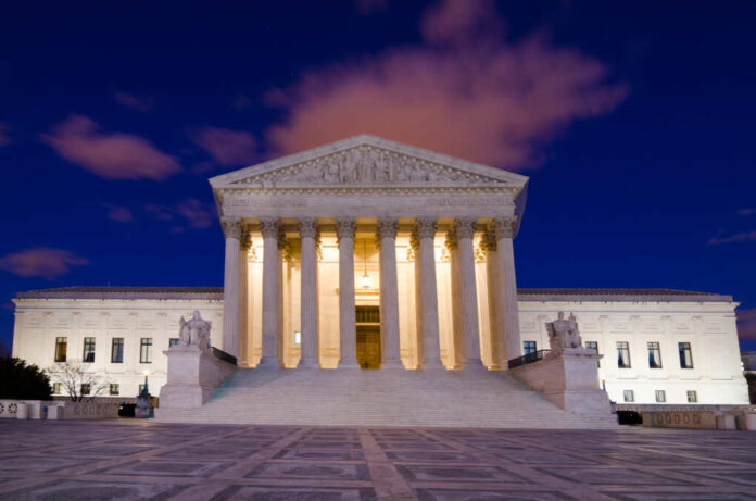 United,States,Supreme,Court,Building,At,Night,In,Washington,,Dc