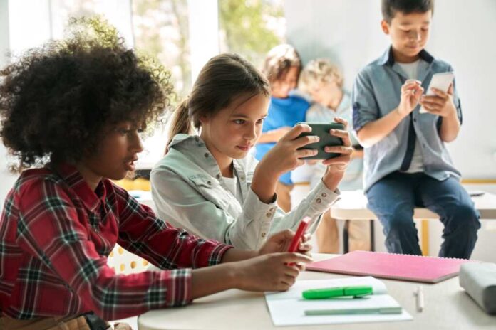 Diverse,Multiethnic,Kids,Students,Using,Smartphones,In,Classroom.,Multicultural,Children