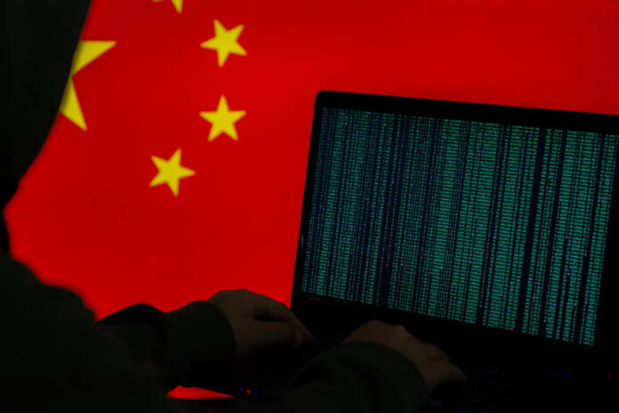 Computer,Hacker,In,Front,Of,Flag