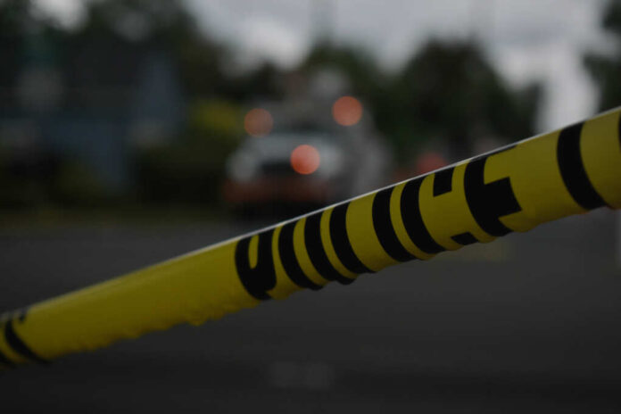 Police,Tape,Across,Road,With,Emergency,Vehicles