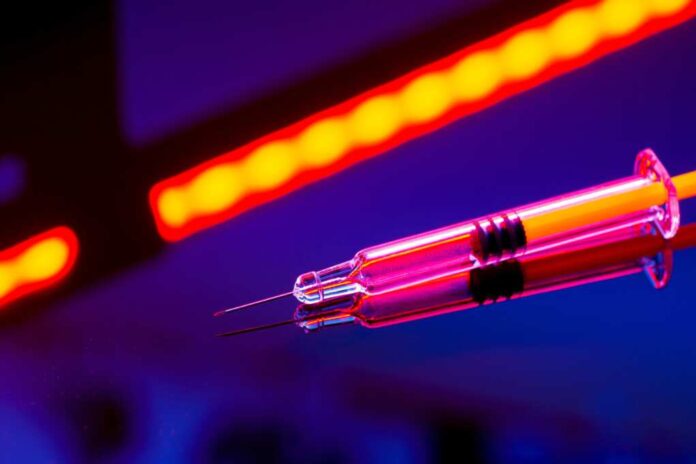 Neon,Glowing,Syringe,On,A,Reflective,Surface