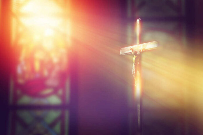 A crucifix illuminated by soft light in a church setting