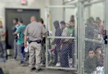 A group of individuals in a detention area with a security officer present