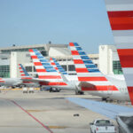 Multiple American Airlines airplanes parked at an airport terminal