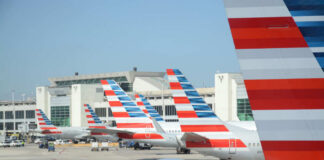 Multiple American Airlines airplanes parked at an airport terminal