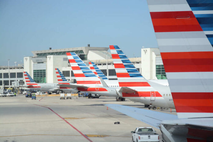 Multiple American Airlines airplanes parked at an airport terminal