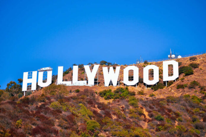 Hollywood sign on a hillside against a clear blue sky