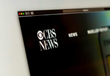 Close-up of CBS News website logo on a computer screen