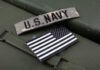 U.S. Navy patch and American flag on a green surface