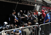A group of people interacting with police officers in an urban environment