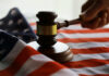 A gavel resting on an American flag, symbolizing justice and law