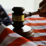 A gavel resting on an American flag, symbolizing justice and law