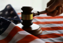 A gavel resting on an American flag, symbolizing justice and law