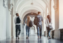 Group of students walking together in a university hallway
