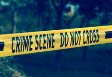 Yellow crime scene tape reading DO NOT CROSS