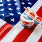 Voting stickers on an American flag background