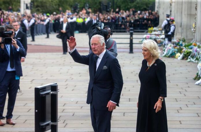 King Charles III and Camilla, Duchess of Cornwall, greeting a crowd during a public event