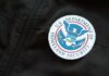 Close-up of a U.S. Department of Homeland Security badge on a black jacket