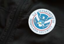 Close-up of a U.S. Department of Homeland Security badge on a black jacket
