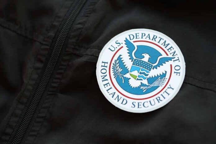 Close-up of a U.S. Department of Homeland Security badge on a black jacket