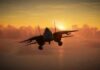 Military aircraft flying against a sunset backdrop