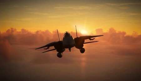 Military aircraft flying against a sunset backdrop