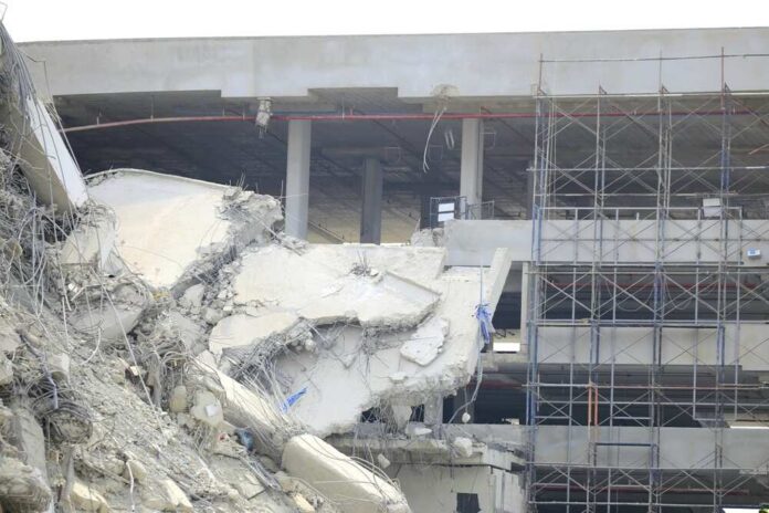 shutterstock_2606782081.jpg Damaged building structure with exposed debris and scaffolding