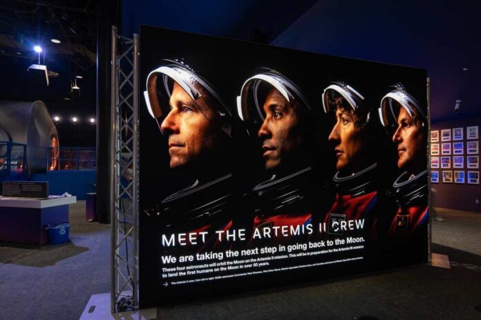 Display featuring the Artemis II crew with astronauts in spacesuits