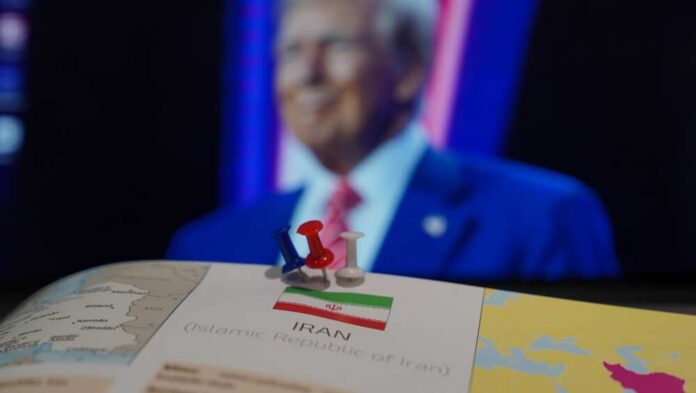 Map of Iran with push pins and a blurred figure in the background