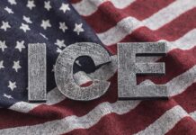 Letters 'ICE' placed on a background of an American flag