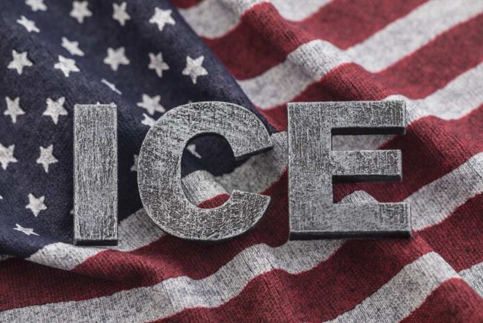 Letters 'ICE' placed on a background of an American flag