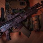 A tactical firearm placed on a military vest with accessories