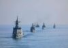 A fleet of military ships sailing in the ocean