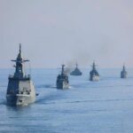 A fleet of military ships sailing in the ocean