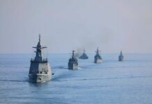 A fleet of military ships sailing in the ocean