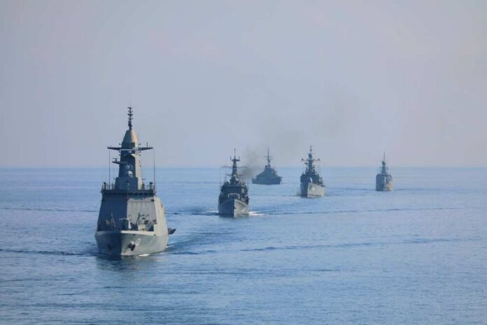 A fleet of military ships sailing in the ocean