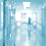 IV drip in a hospital corridor with a blurred background