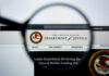 Close-up view of the Department of Justice website through a magnifying glass