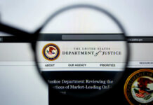 Close-up view of the Department of Justice website through a magnifying glass