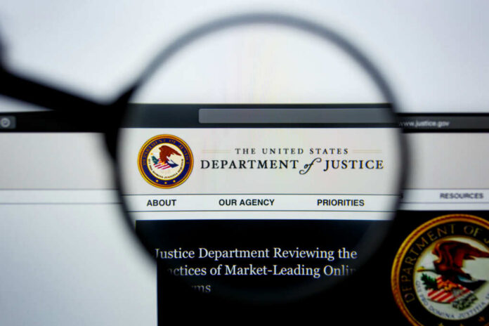 Close-up view of the Department of Justice website through a magnifying glass