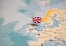 A map of Europe with a small flag of the United Kingdom pinned on it