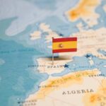 Map highlighting Spain with a small flag