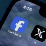 Close-up of smartphone screen displaying Facebook and X app icons