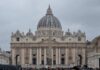 St. Peters Basilica in Vatican City with a cloudy sky and a large obelisk in the foreground