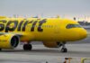 A yellow Spirit Airlines airplane on the runway