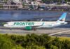 Frontier Airlines airplane on the runway at an airport