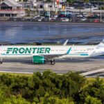 Frontier Airlines airplane on the runway at an airport