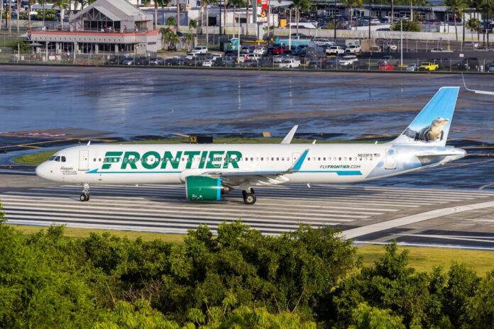 Frontier Airlines airplane on the runway at an airport