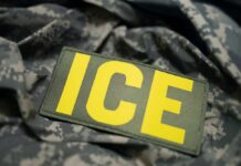 California Candidate’s SHOCKING Move: ICE Agents Targeted! Close-up of a military patch with the letters ICE on a camouflage background